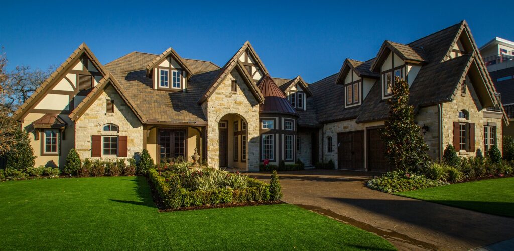 A home featuring a spacious front yard adorned with artificial grass.